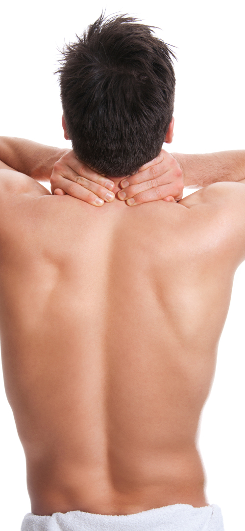 man rubbing his neck after a back wax